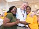 The St. Jude After Completion of Therapy Clinic director, Tim Folse, hugs two women.