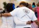 A woman and St. Jude survivor walk away from the camera with their arms around each other.