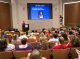 A wide view of Wendy Harpham speaking at the event.