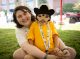 Emily Hines smiles with a St. Jude patient survivor sitting in her lap.