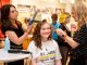 A teen gets her hair styled.