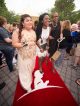 Three young women walking the red carpet.