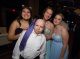 Young man posing with three young ladies.