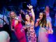 A group of girls dance at the prom.