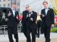 Four guys pose for the camera before they go into prom.