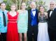 Three prom couples posing for picture