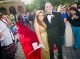 Prom couple walking the red carpet into the event
