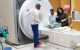 Mary Jo Freeman (center) and her colleagues assist a patient prior to an MRI scan.