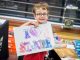 Josiah holding a sign