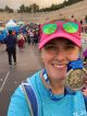 Lexie Johnston holding up a medal after finishing the marathon in Athens, Greece