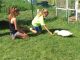 Catherine and her sister feeding their duck outside the garden