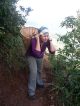 Tremblay assists with the building of a school in Nepal by toting rocks up a mountain path.