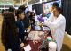 Volunteers work a booth at inspire expo
