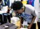 Expo participant looks through microscope