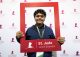 Expo participant holds up St. Jude Junior Scientist social media frame