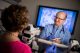 Paul Lavoie, a physician assistant in Hematology, examines blood smear slides in the Hematology clinic’s microscope room.