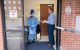 Charles Coe, RN, director of outpatient services in Nursing, discusses screening procedures with Gheri Terry, RN, Outpatient Clinics, at the isolation entrance.