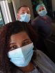 3 people in PPE in a van