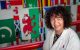 Ruth Tatevossian, MD, PhD, stands near the Welsh flag