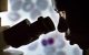 Man looking through microscope
