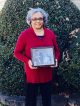 Deborah Williamson holding a photo of her late sister and St. Jude patient, Lisa Smith
