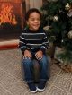 St. Jude patient Donovan in a blue shirt sitting