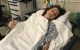 St. Jude patient fletcher in a hospital bed with a thumbs up