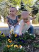 st. jude patient lily with her sister in a garden.