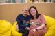 St. Jude patient Rinoa sits with her mother in a yellow chair.