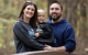 St. Jude patient Beckett and his parents pose on a bridge in an outdoor setting.