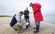 Pamela McKenzie and Robert Webster gather around a cooler while Jon Seiler inserts samples.