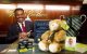 Ricky Bunting of Brooks Brothers smiles alongside St. Jude gifts that can be purchased.