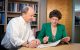 Leslie Robison, MD, and Melissa Hudson, MD, at a table