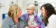 Nurse practitioner Katie Birdsell with a patient and her mother