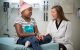 Jamie Flerlage, MD, talks with patient Shamaria in an exam room