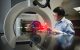Weiguang Yao, PhD examines the proton therapy machine.
