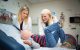 Graduate student Madeline Bush (at left) joins oncologist Beth Stewart, MD, in examining patient Holden Giroir.