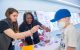 Jamie Maciaszek, PhD, and Stacy Hines-Dowell, DNSc, both of Cancer Predisposition, assist Christian Trey Hall with the DNA extraction.