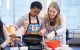 Marley Harris cooks pancakes under the guidance of St. Jude Clinical Nutrition student Hannah Cox.