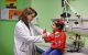 Raya Saab, MD examines a child