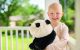 Caroline McKinney smiles while holding a stuffed panda bear.