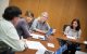 The histiocytosis treatment team sits around a table and discusses treatment plans.