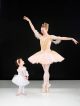 Crystal Brothers of Ballet Memphis strikes a ballet pose with Zoey Smith looking on.