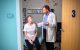 Giles Robinson, MD, consults with patient Chelsea in an exam room