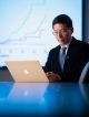 Zhaoming Wang, PhD, uses a computer on a desk