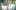 Two doctors in white lab coats look straight into camera.