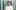 Woman in lab coat smiling at camera.