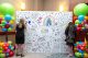 Anchor of Hope attendees color a wall of drawings by St. Jude patients. 