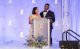 Jonathan and Natalie Stewart stand behind a podium at the St. Jude Celebrity Chef and Wine Dinner. 