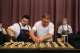 A chef drizzles sauce across tasting plates. 